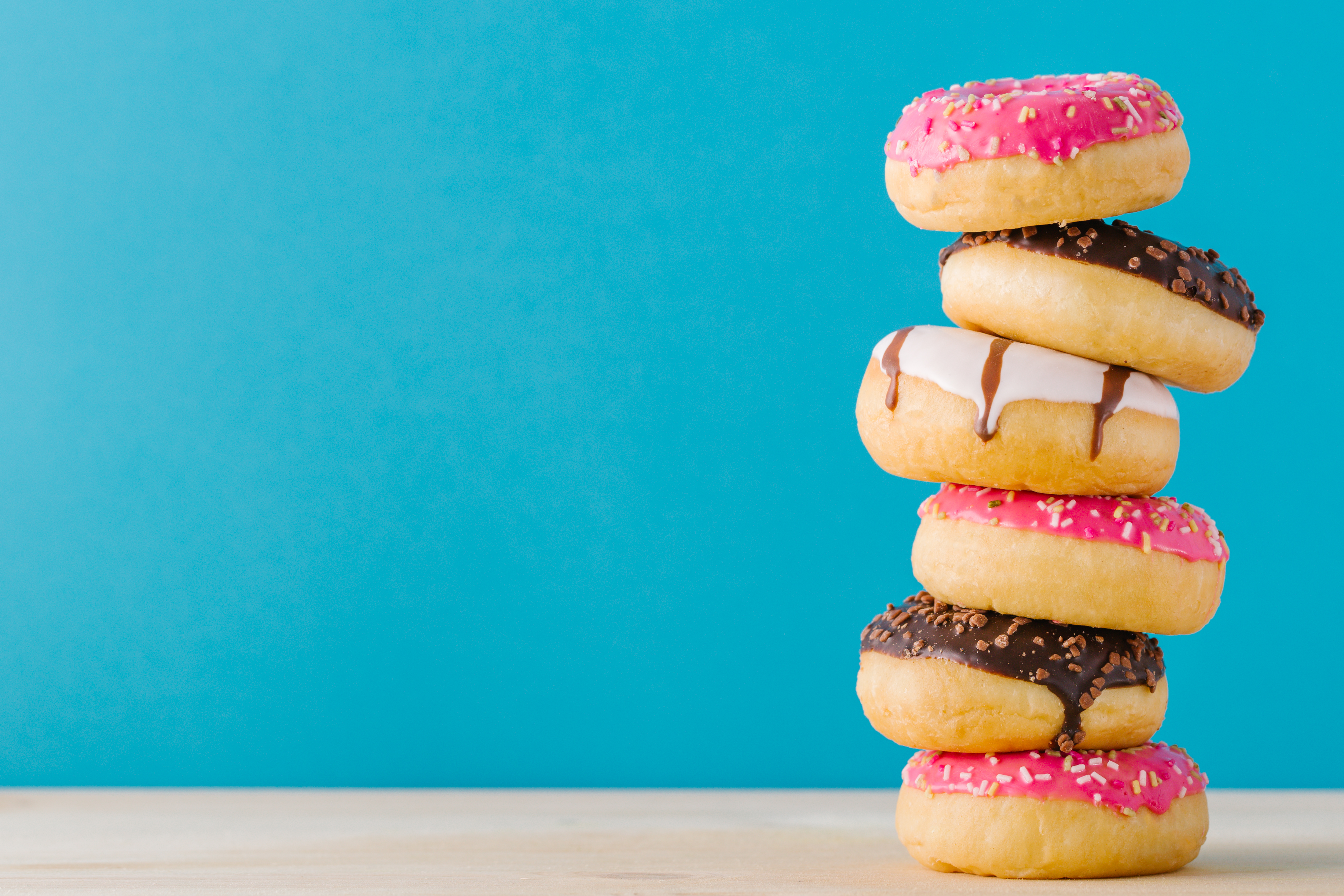 Stacked doughnuts on a blue background. 