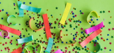 Colorful confetti on a green background.