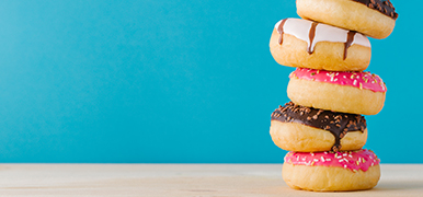 Stacked doughnuts on a blue background. 