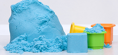 Blue kinetic sand with shaping molds.