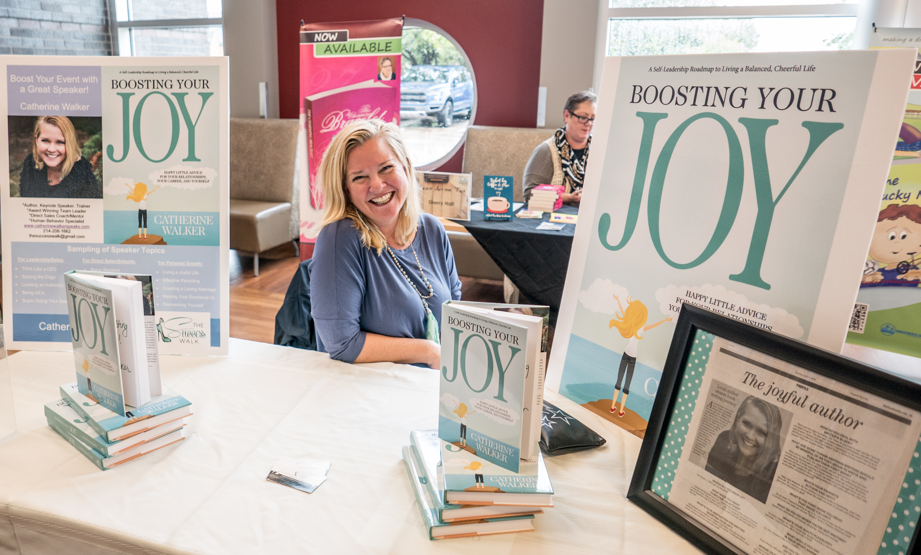 Photo from the 2018 Indie Author Fair at the Cozby Library. Author smiling at her booth.