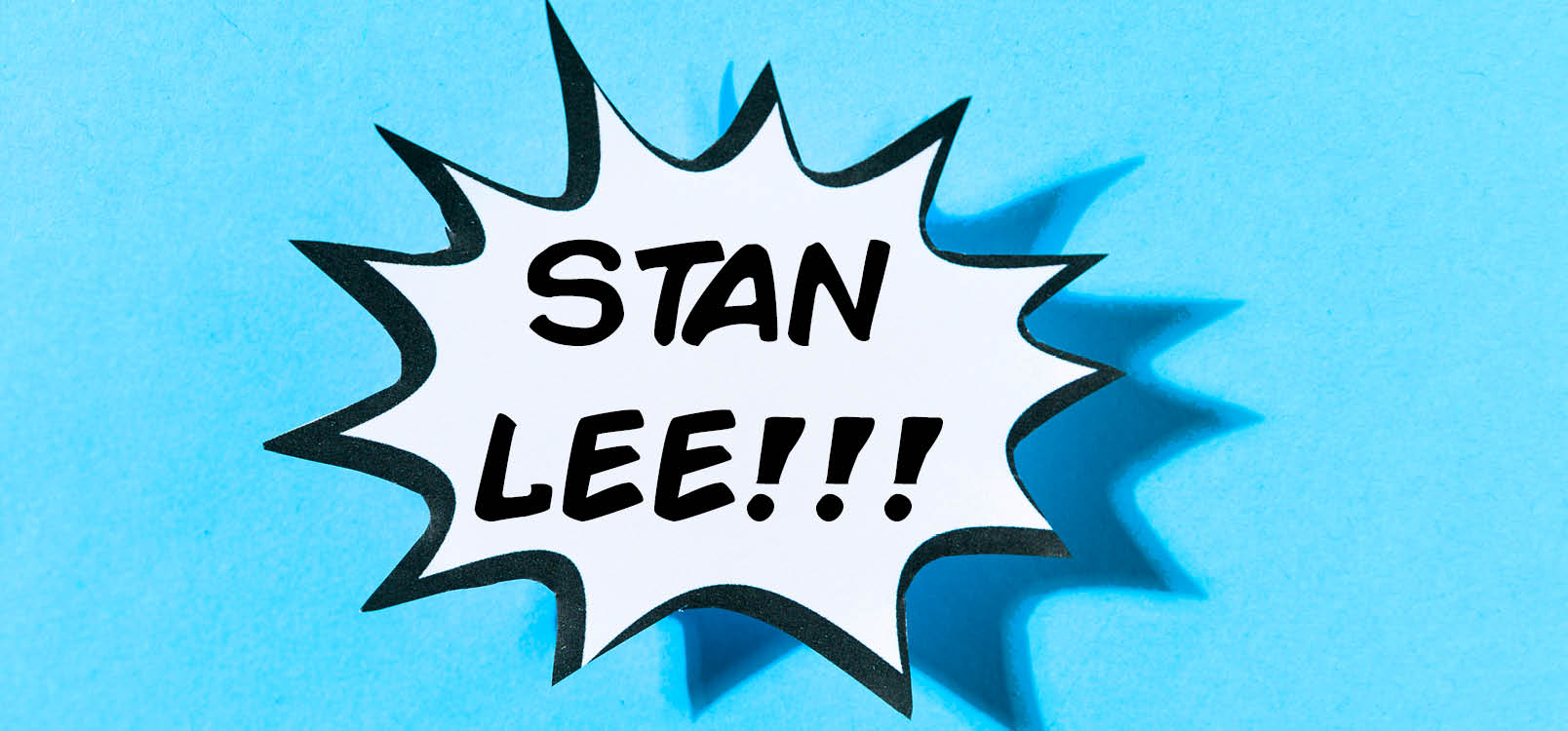 Speech bubble with Stan Lee!!! written in it on a blue background.