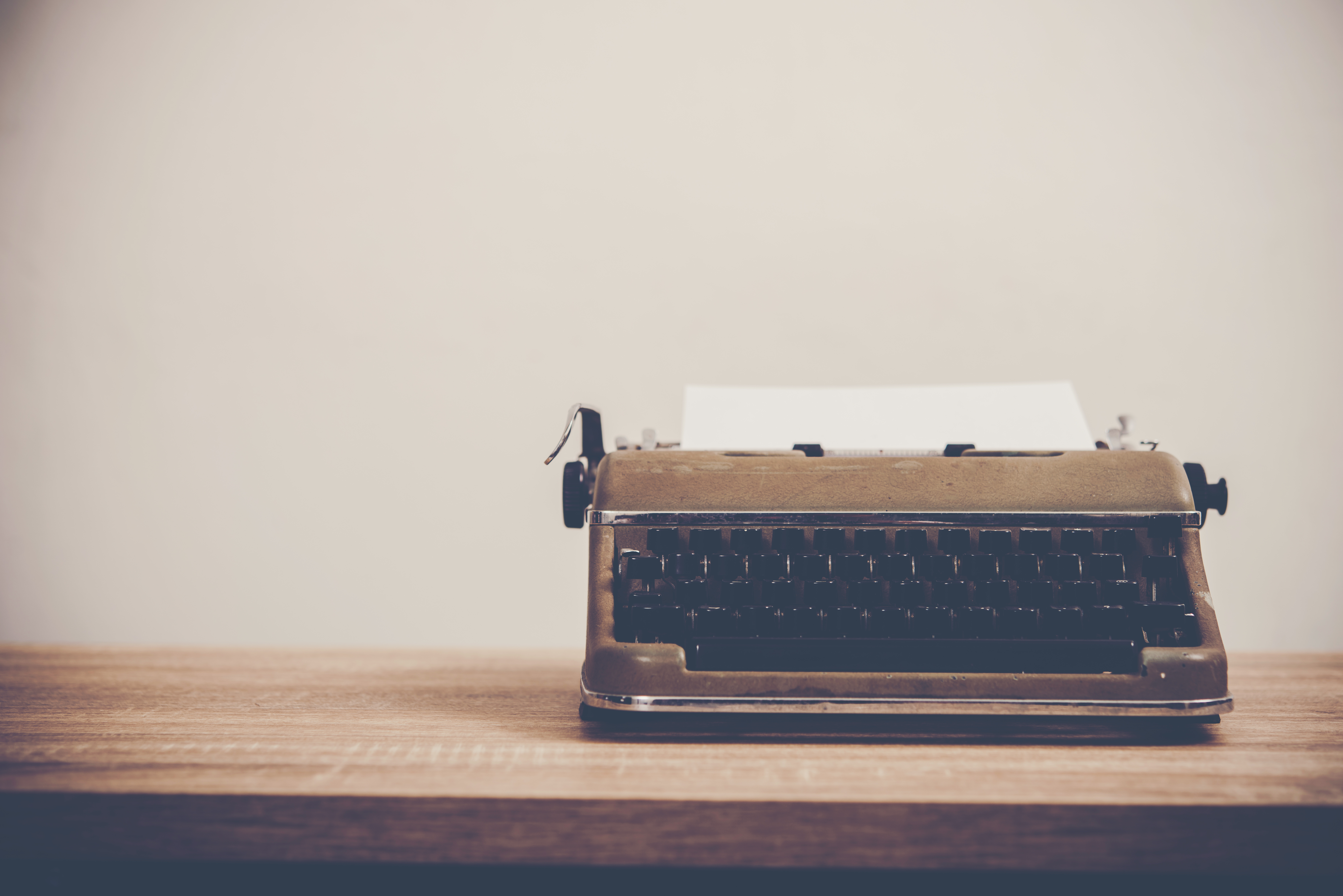 Typewriter on a wooden desk.