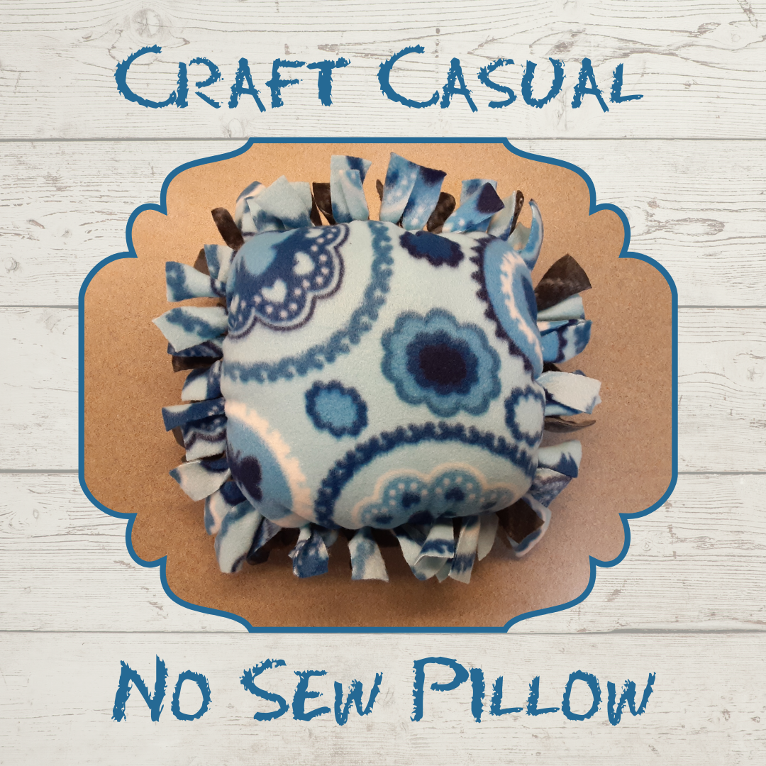 A picture of a new sew pillow in shades of blue.  The text "Craft Casual" is above the picture and the text "No Sew Pillow" is below the picture.