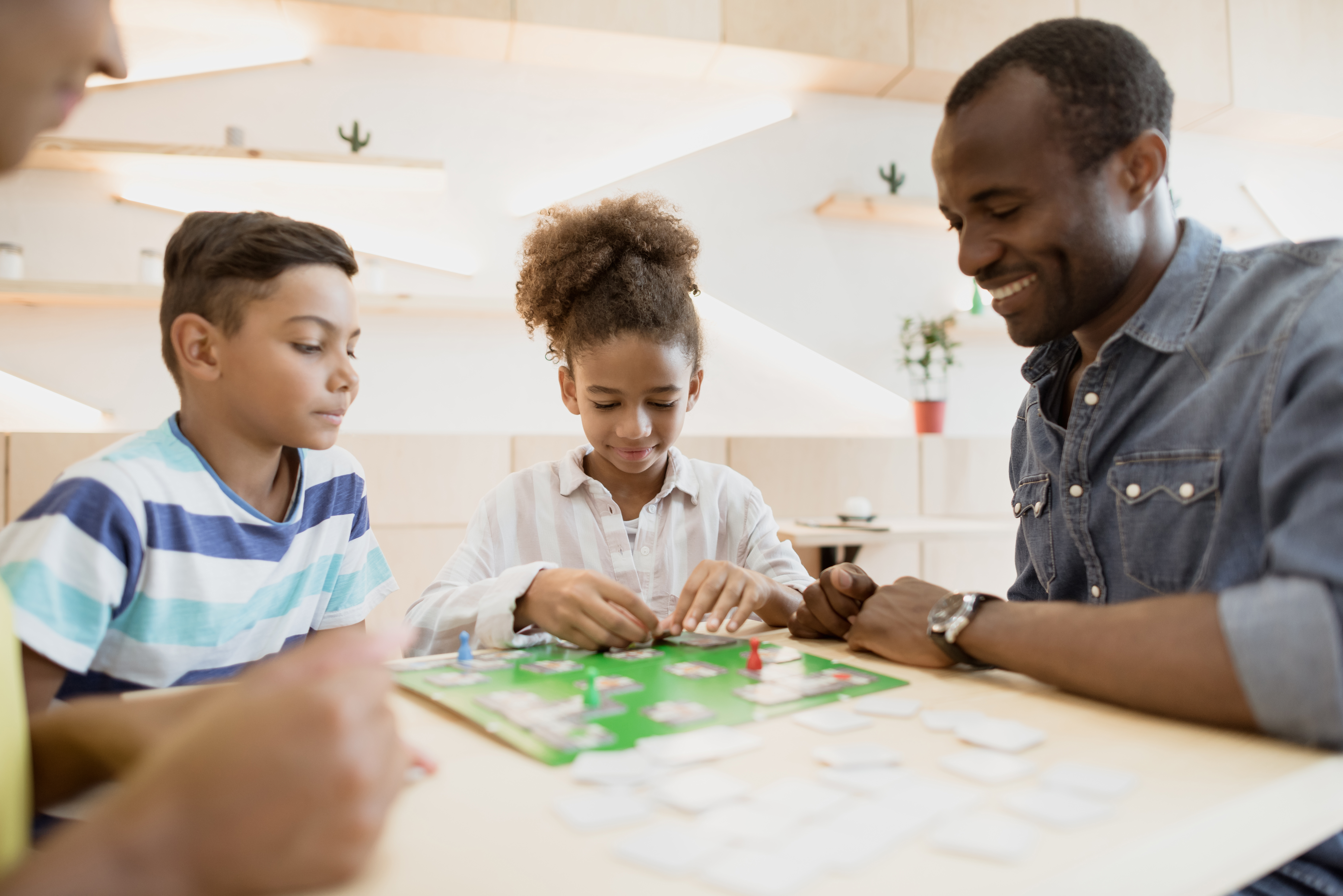 African American family playing a board game