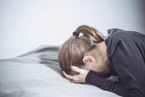 Woman with her head in her hands.