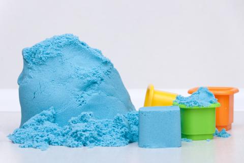 Blue kinetic sand with shaping molds.