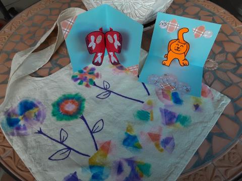 Two pop up cards and a canvas bag decorated with markers in a tie dye design.