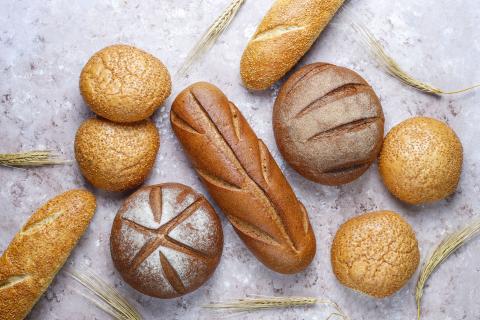 Several loaves of bread on a white surface.