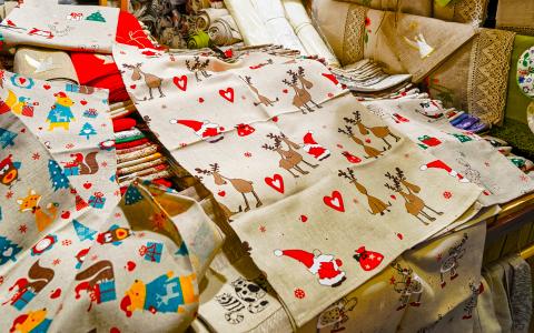 Piles of holiday linens as tablecloths