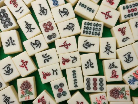 Close up of mahjong tiles on a green table