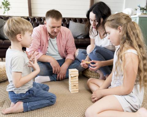 A family playing Jenga in their living room