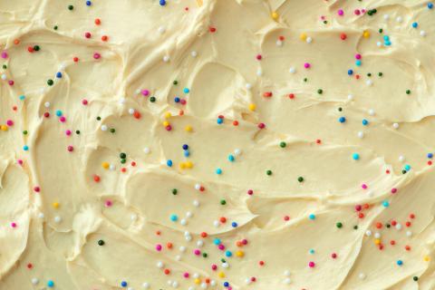 White frosting with rainbow sprinkles.