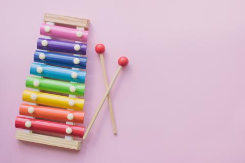 Toy xylophone on pink background.