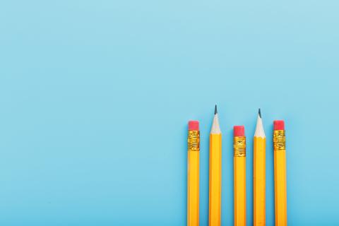 Sharpened pencils on a blue background.