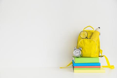 Yellow backpack with school supplies.