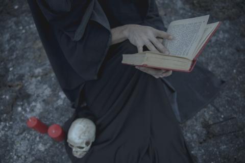A person in black reading a book