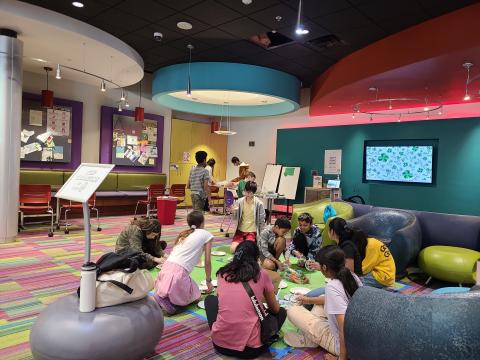 Teens sitting on the floor crafting.