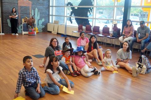Children sitting on the floor listening to storytime.