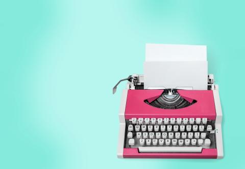 Retro typewriter on a blue background.