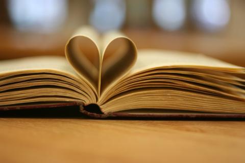 Open book with pages folded to make a heart