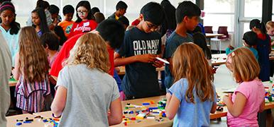 Kids playing with legos at a table.