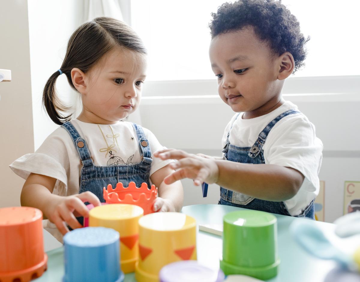 Two small kids playing with educational toys