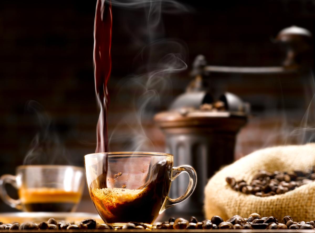 Photo of a cup of coffee with coffee beans