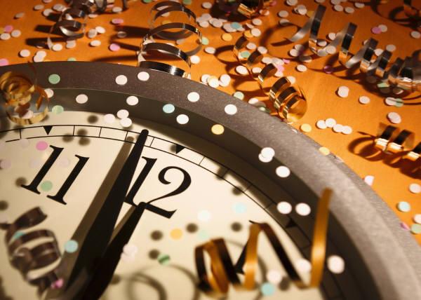 Clock counting down to midnight with confetti.