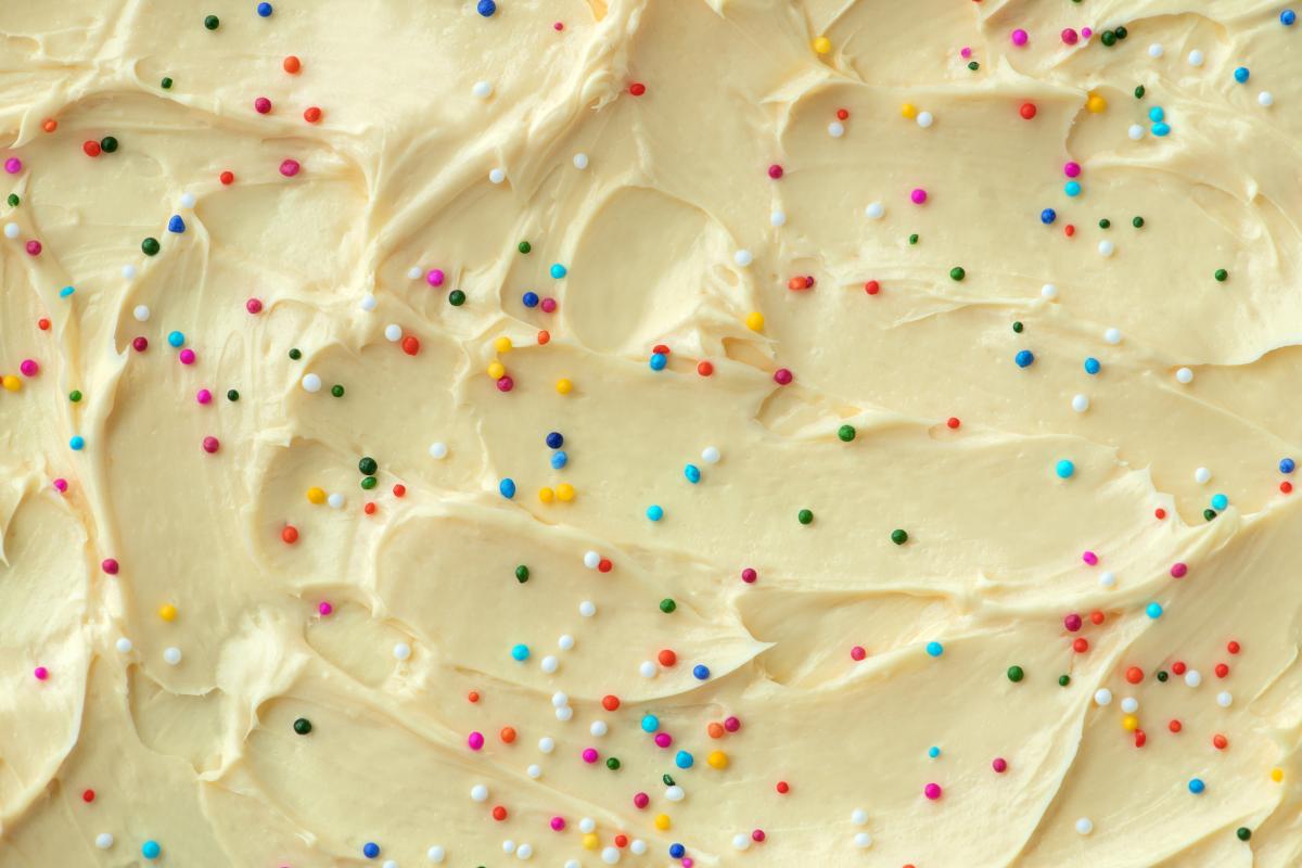 White frosting with rainbow sprinkles.