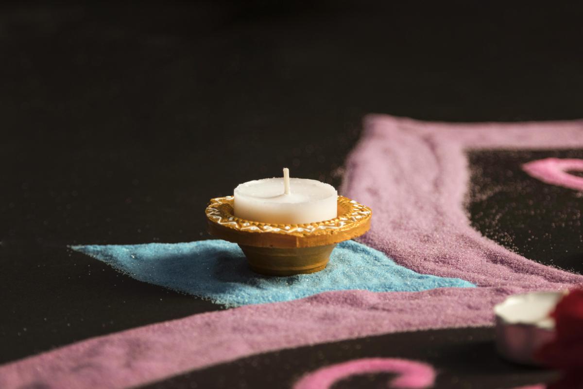 A rangoli design with a tealight.