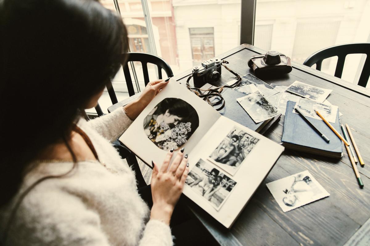 Woman looking at photo album.