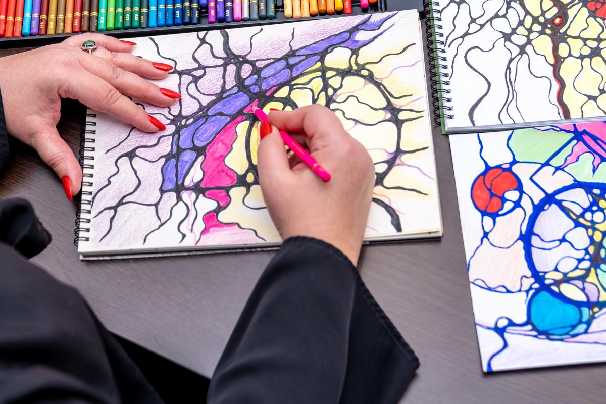 A man's cropped hand using a digital tablet