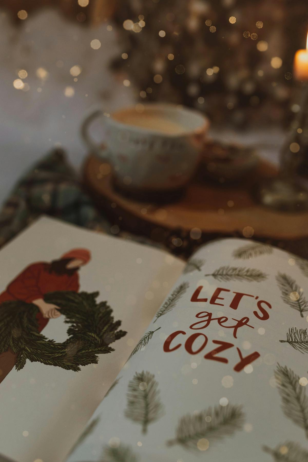 image of book with the words Let's get Cozy, with a Christmas tree, and a warm cup