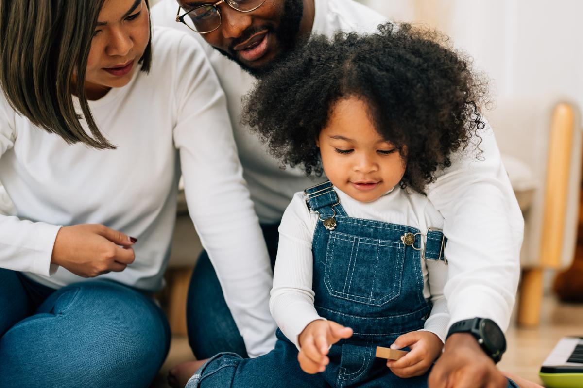 Happy family with father, mother, and daughter at home
