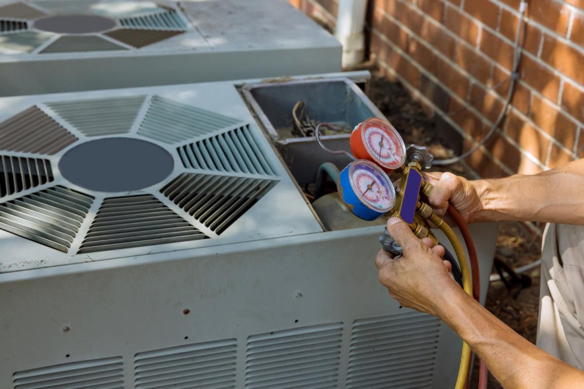 Hands preparing an HVAC system
