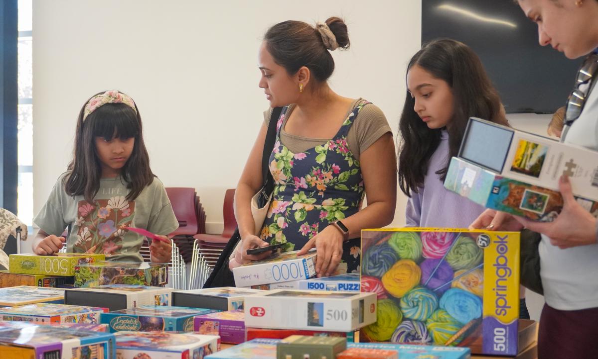 Children and adults crafting at a table.